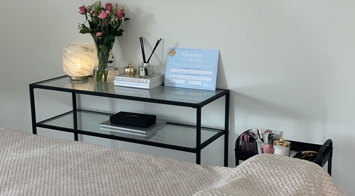 Peaceful setting at Rose Clark Beauty in Herne Bay, England, featuring a cozy table with flowers and soft lighting.
