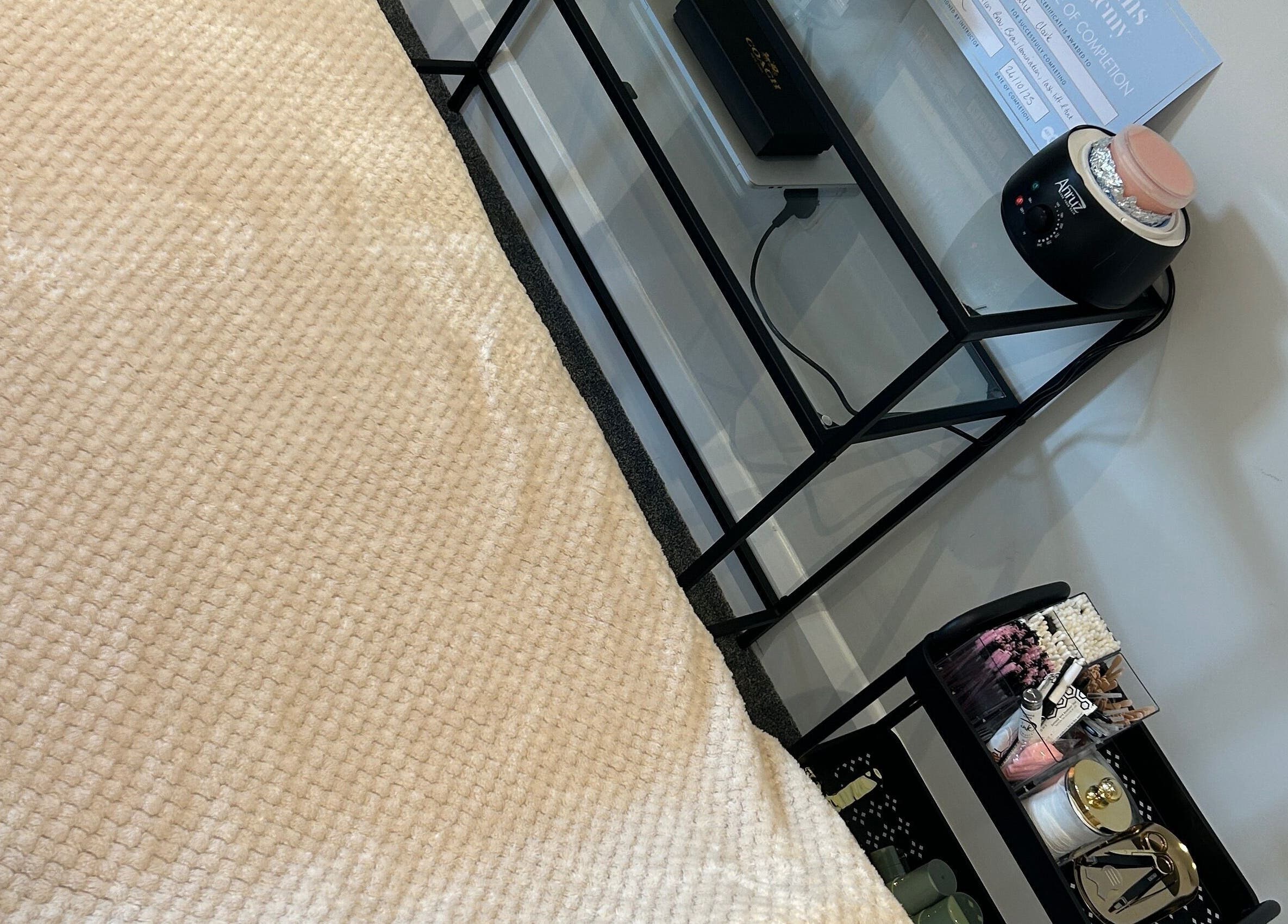 Cozy treatment bed and beauty tools at Rose Clark Beauty, Herne Bay, England, GB for a serene experience.