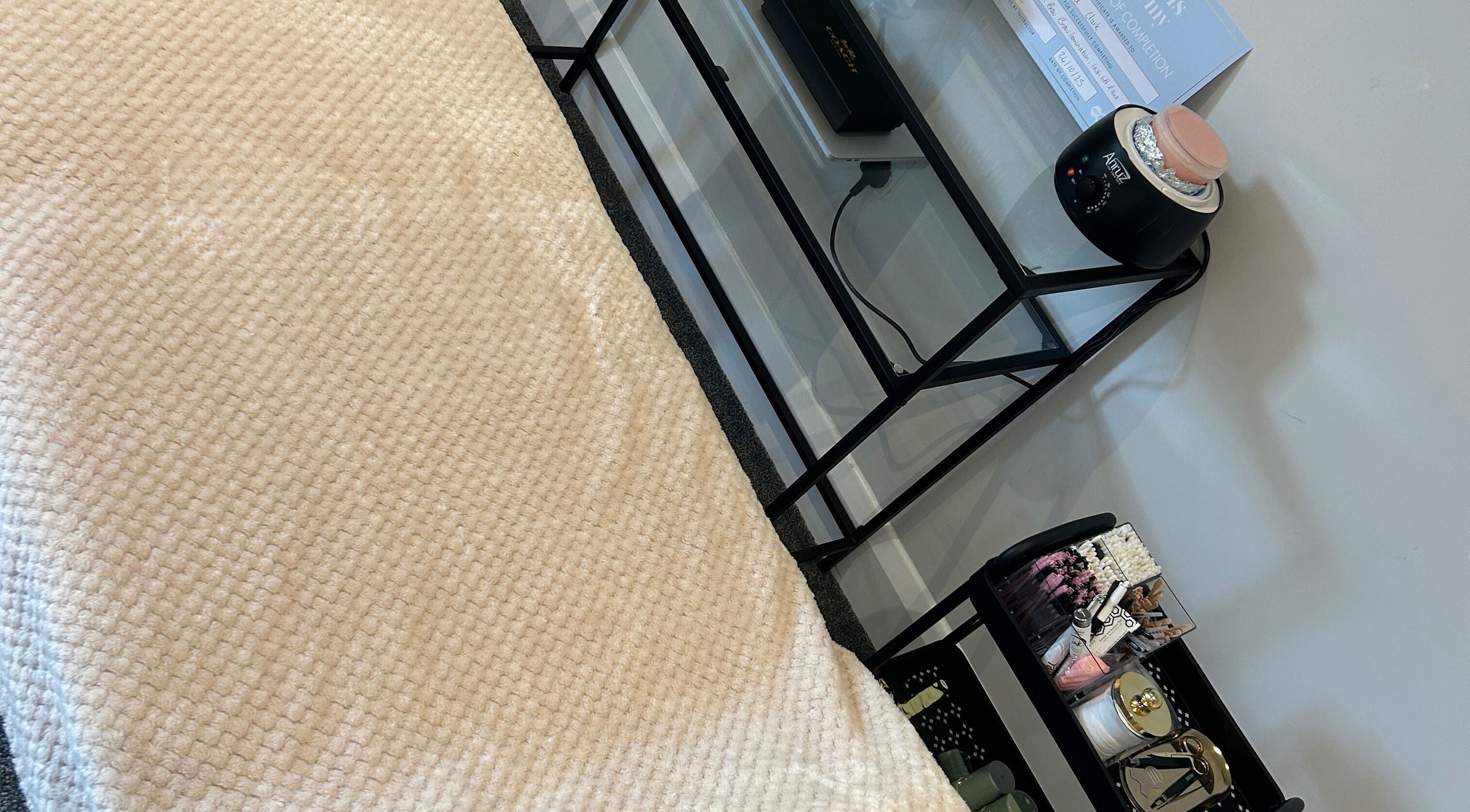 Cozy treatment bed and beauty tools at Rose Clark Beauty, Herne Bay, England, GB for a serene experience.