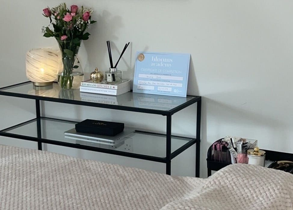 Elegant beauty setup at Rose Clark Beauty in Herne Bay, England, GB with flowers and serene lighting.