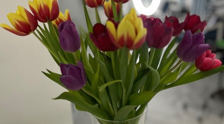 Colorful tulips in a vase at Friseursalon Grande Grunewald, Berlin, Berlin, DE, enhancing the salon's ambiance.