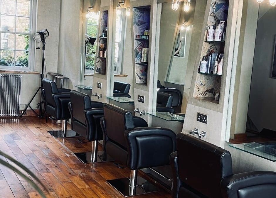 Chic interior of Transition Salon, London, England, GB featuring elegant styling stations and natural light.