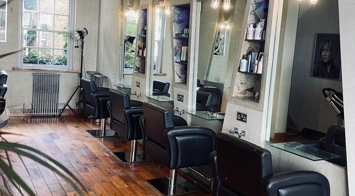 Chic interior of Transition Salon, London, England, GB featuring elegant styling stations and natural light.