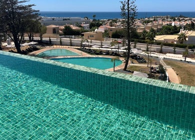 Infinity pool at Slow Living Spa - Ananea Castelo Suites Hotel overlooking Albufeira, PT with ocean view.