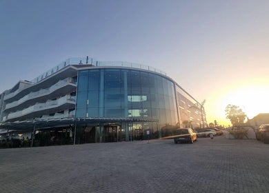 Sunset view of Slow Living Spa - Ananea Castelo Suites Hotel, Albufeira, PT, with sleek modern architecture.