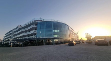 Sunset view of Slow Living Spa - Ananea Castelo Suites Hotel, Albufeira, PT, with sleek modern architecture.