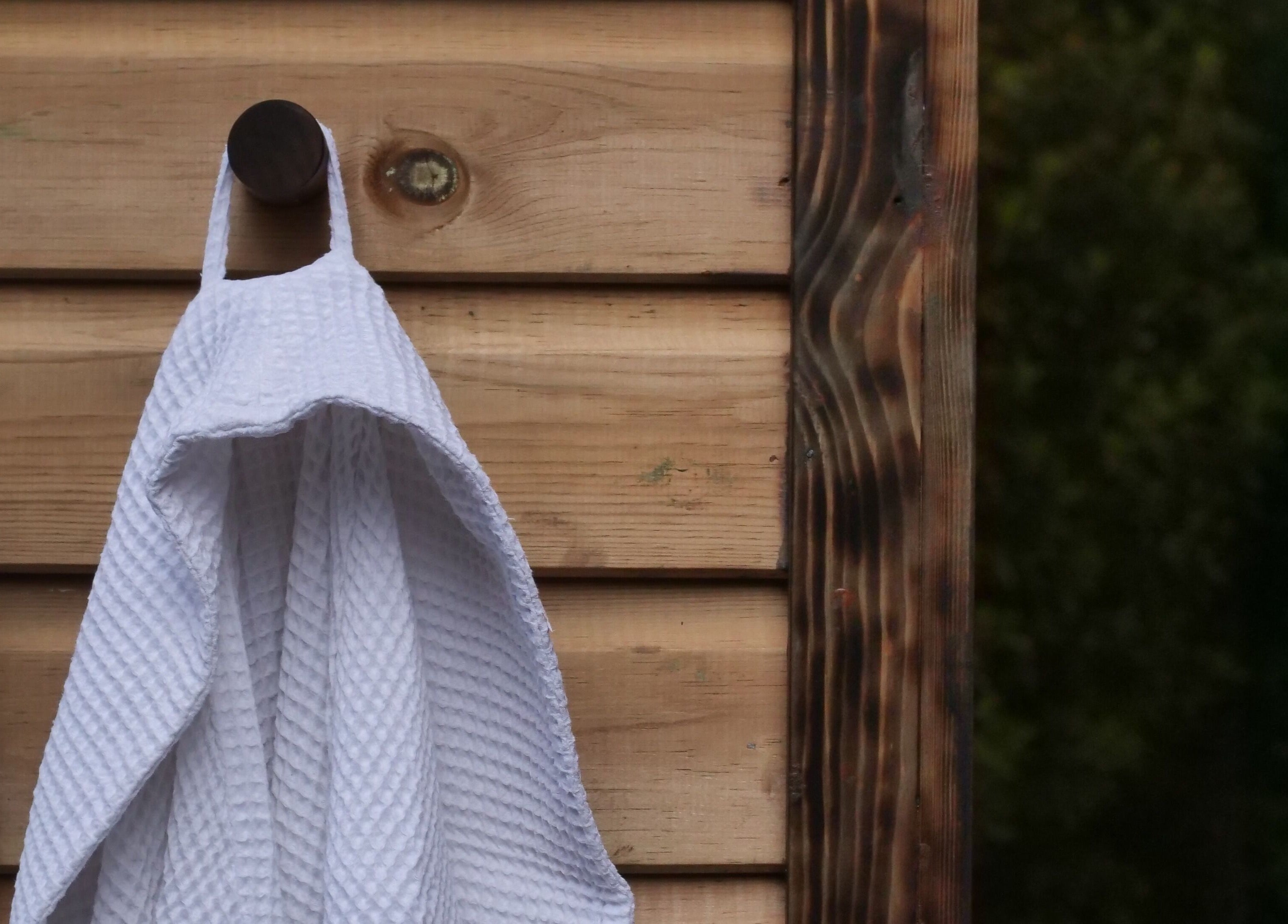White towel hanging on wooden panel at Phoenix Burning Sauna in London, England, GB.