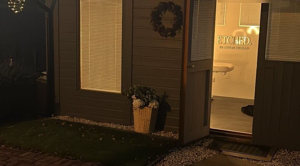 Charming entrance of ETCHED.byMeganBuchan in Leven Fife, Scotland, GB, warmly lit at night.