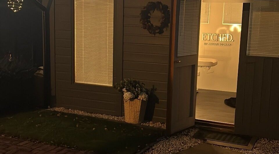 Charming entrance of ETCHED.byMeganBuchan in Leven Fife, Scotland, GB, warmly lit at night.