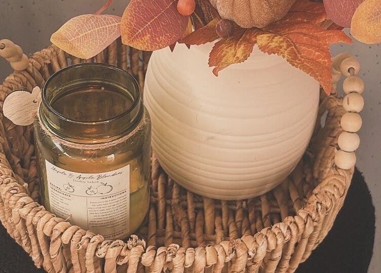 Cozy autumn decor at ETCHED.byMeganBuchan, Leven Fife, Scotland, GB, featuring candle and vase in a woven basket.