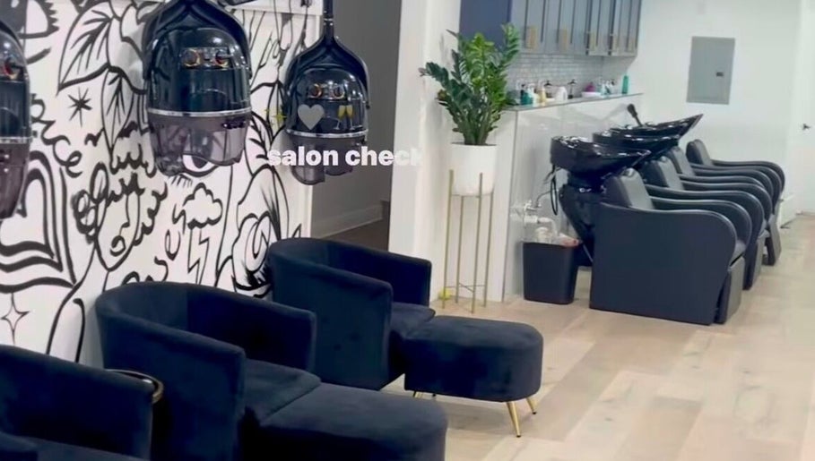 Modern interior of Creative Hands Salon, Tampa, Florida, US with stylish chairs and wash stations.
