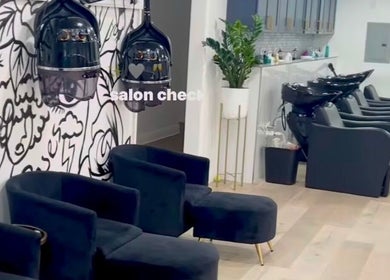 Modern interior of Creative Hands Salon, Tampa, Florida, US with stylish chairs and wash stations.