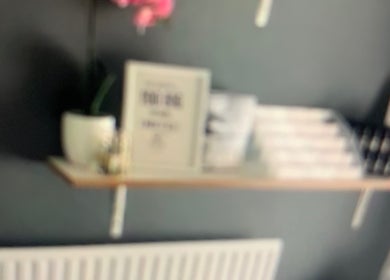 Elegant shelf with decor at Skin & Laser Aesthetics, Smethwick, England, GB. Features a pink orchid and framed art.