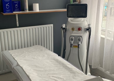 Skin & Laser Aesthetics Smethwick, England treatment room with laser machine and bed.