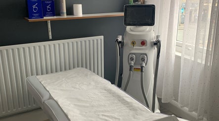 Skin & Laser Aesthetics Smethwick, England treatment room with laser machine and bed.