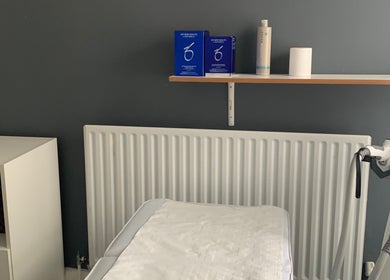 Treatment room at Skin & Laser Aesthetics, featuring equipment and a cozy setup in Smethwick, England, GB.