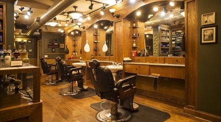 Cozy vintage barbershop at Quick n Easy, Birmingham, Alabama, US, featuring classic leather chairs and wooden accents.