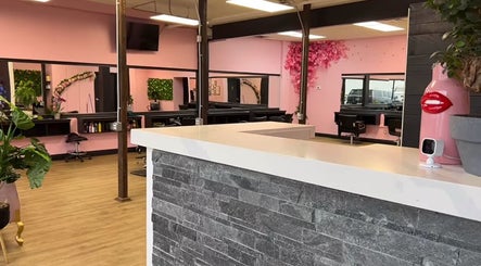 Elegant salon interior at Root 2 Soul, Pickering, Ontario, CA with pink walls and modern decor.