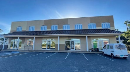 Exterior view of Licithestylist venue in Freeport, BS with spacious parking area.