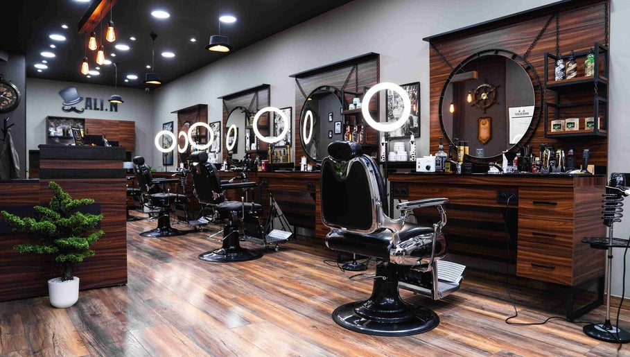 Chic interior of Ali N Barbershop in Den Haag, Zuid-holland, NL, featuring modern barber chairs and lighting.