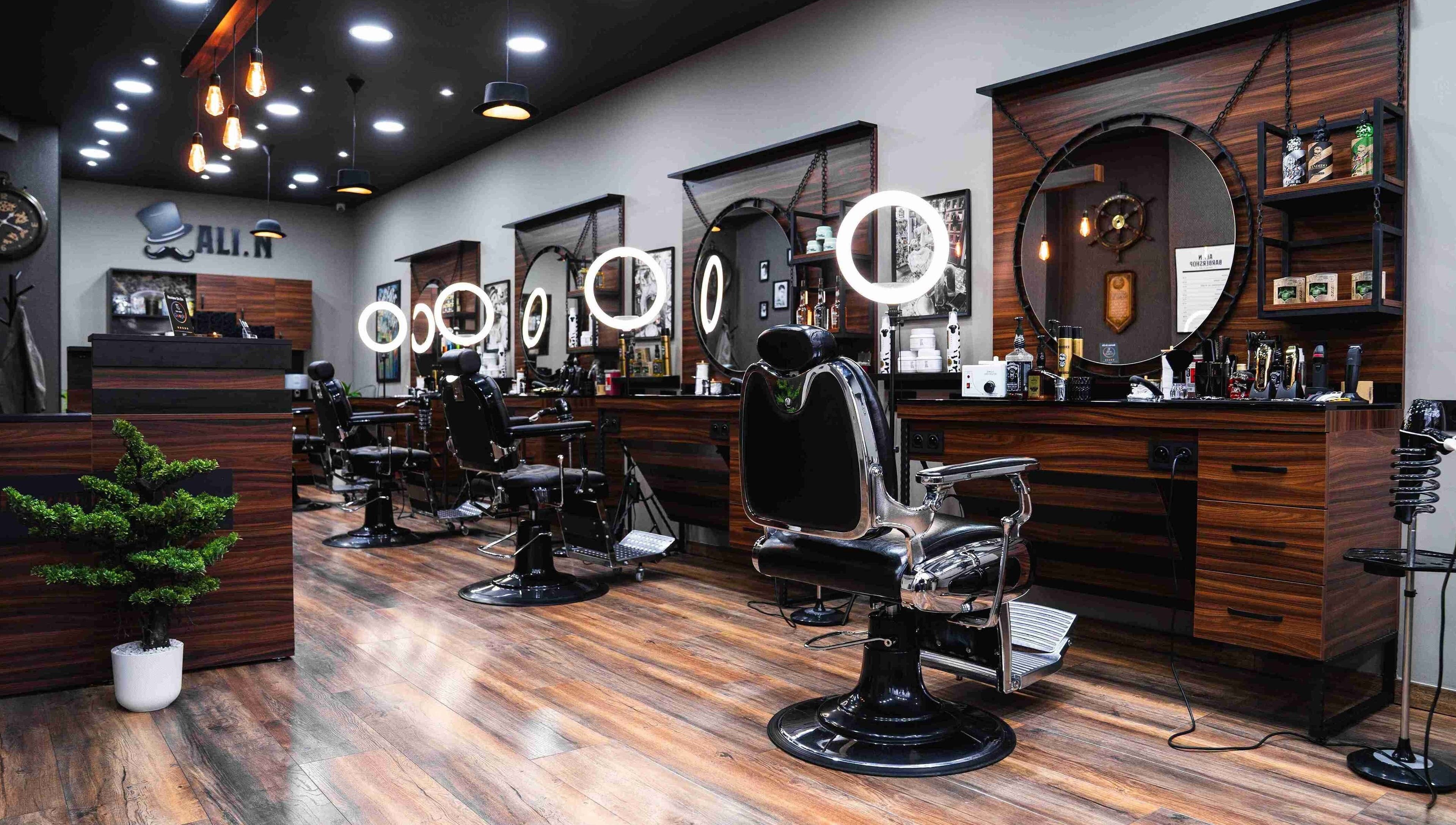 Chic interior of Ali N Barbershop in Den Haag, Zuid-holland, NL, featuring modern barber chairs and lighting.