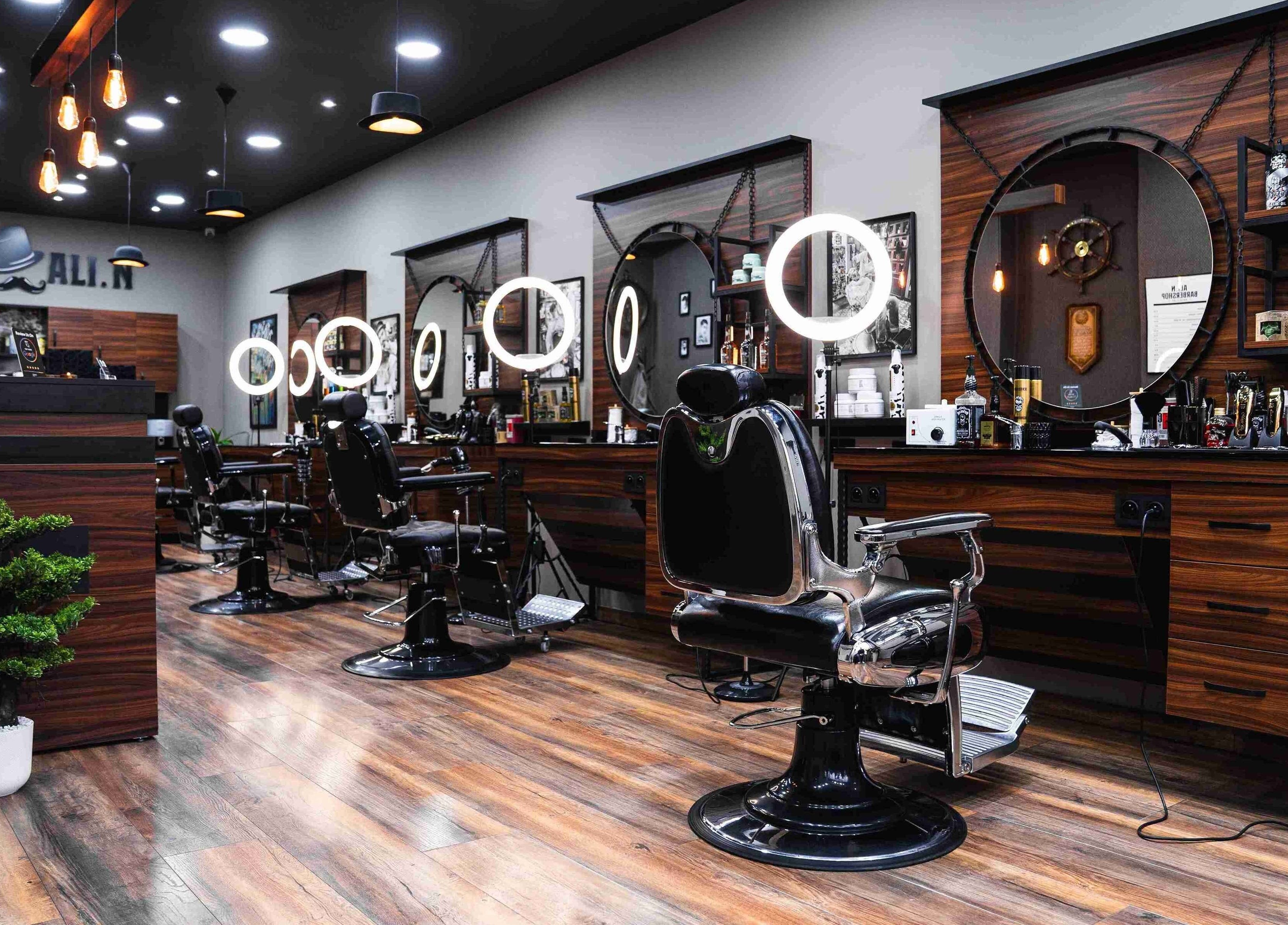 Chic interior of Ali N Barbershop in Den Haag, Zuid-holland, NL, featuring modern barber chairs and lighting.