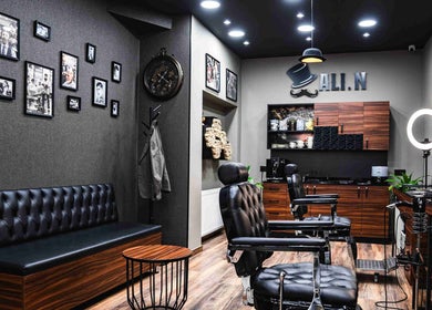 Cozy interior of Ali N Barbershop in Den Haag, Zuid-Holland, NL featuring stylish decor and vintage barber chairs.