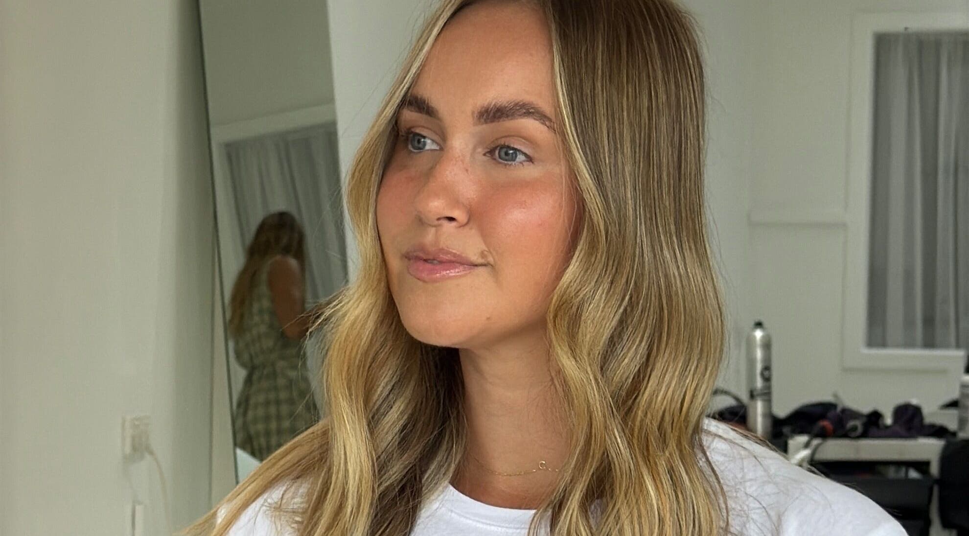 A woman with styled blonde hair at Playa Salon - Indycolour, Tugun, Queensland, AU, showcasing beauty and confidence.