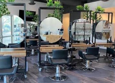 Modern salon interior at Hairdonebyv, Los Angeles, California, US with stylish stations and greenery.