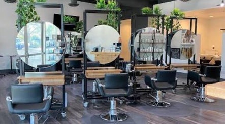 Modern salon interior at Hairdonebyv, Los Angeles, California, US with stylish stations and greenery.