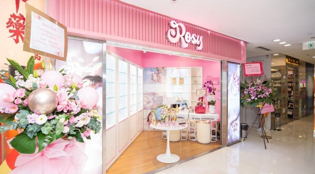 Entrance to Rosy Nails (TST) in Kowloon, HK, featuring a floral display and pink interior decor.