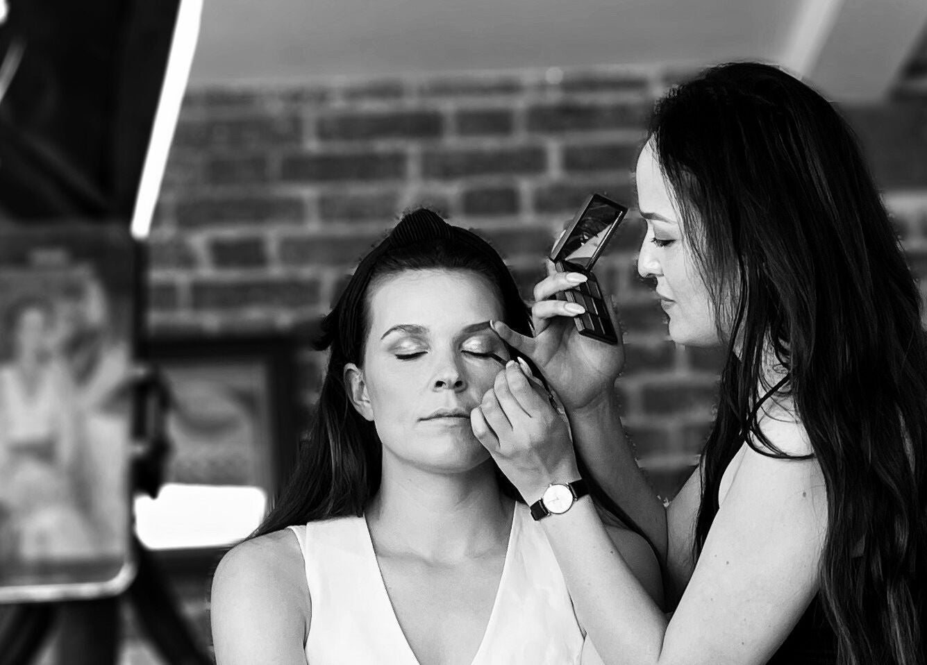 Makeup artist enhancing eyes at Melissa’s Artistry Collective, North West, North West, ZA.