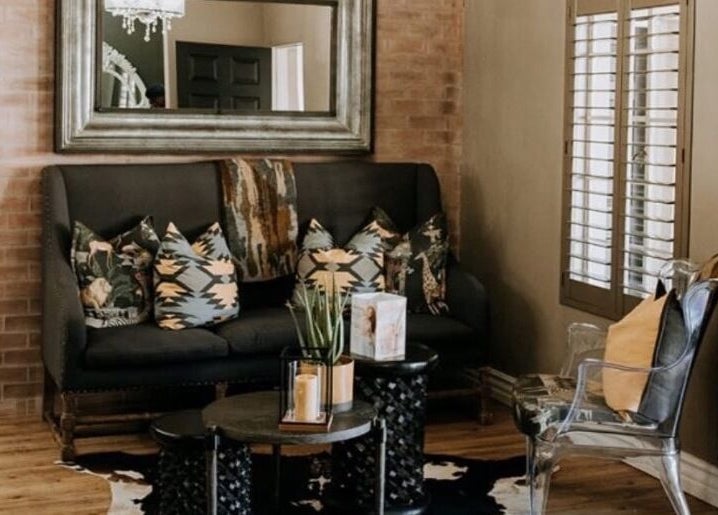 Stylish seating area at Melissa’s Artistry Collective, North West, North West, ZA with plush pillows.