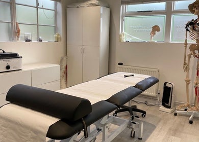 Therapy room at Active Remedy in Norwich, England, GB with massage table and anatomical model.