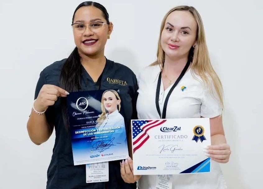 Dos personas sosteniendo certificaciones en Kg_nails_aruba, ubicado en Noord, AW.