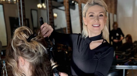 Stylist curling hair at Dina Laurent Hair | Mind-Beauty Studio, Coquitlam, British Columbia, CA.