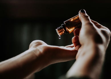 Aromatic oil drops in hand at The Skin Sanctuary, Aylmer, Ontario, CA promoting relaxation and wellness.