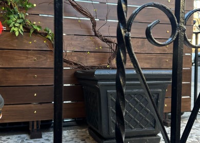 Elegant planter with vines at Spa Maluge entrance, Hoboken, New Jersey, US, creating a peaceful vibe.