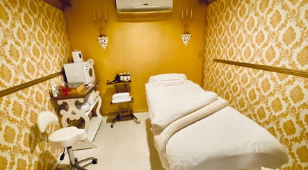 Elegant treatment room at Spa Maluge, Hoboken, New Jersey, US, featuring plush bed and ornate decor.