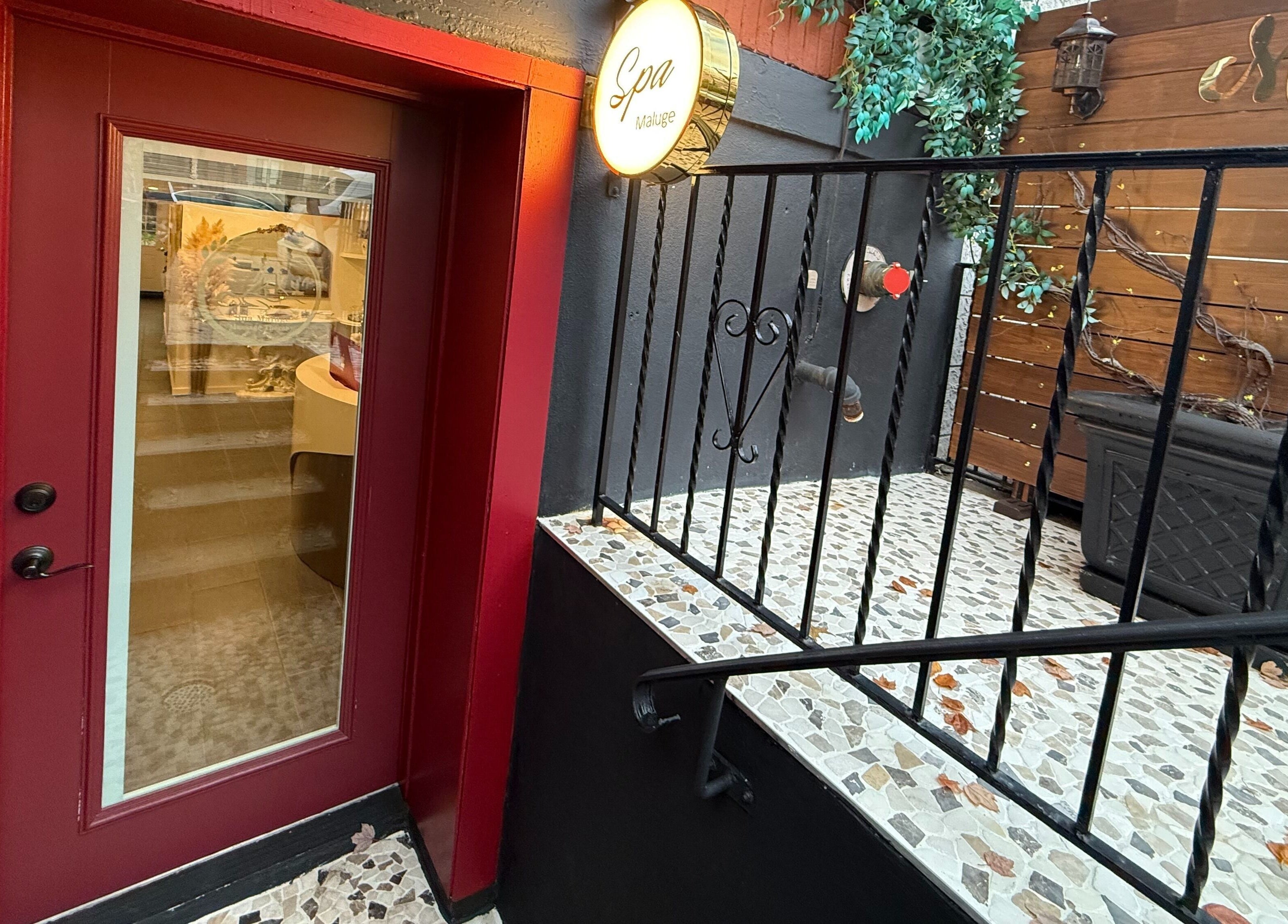 Inviting entrance of Spa Maluge with red door in Hoboken, New Jersey, US lined with decorative accents.