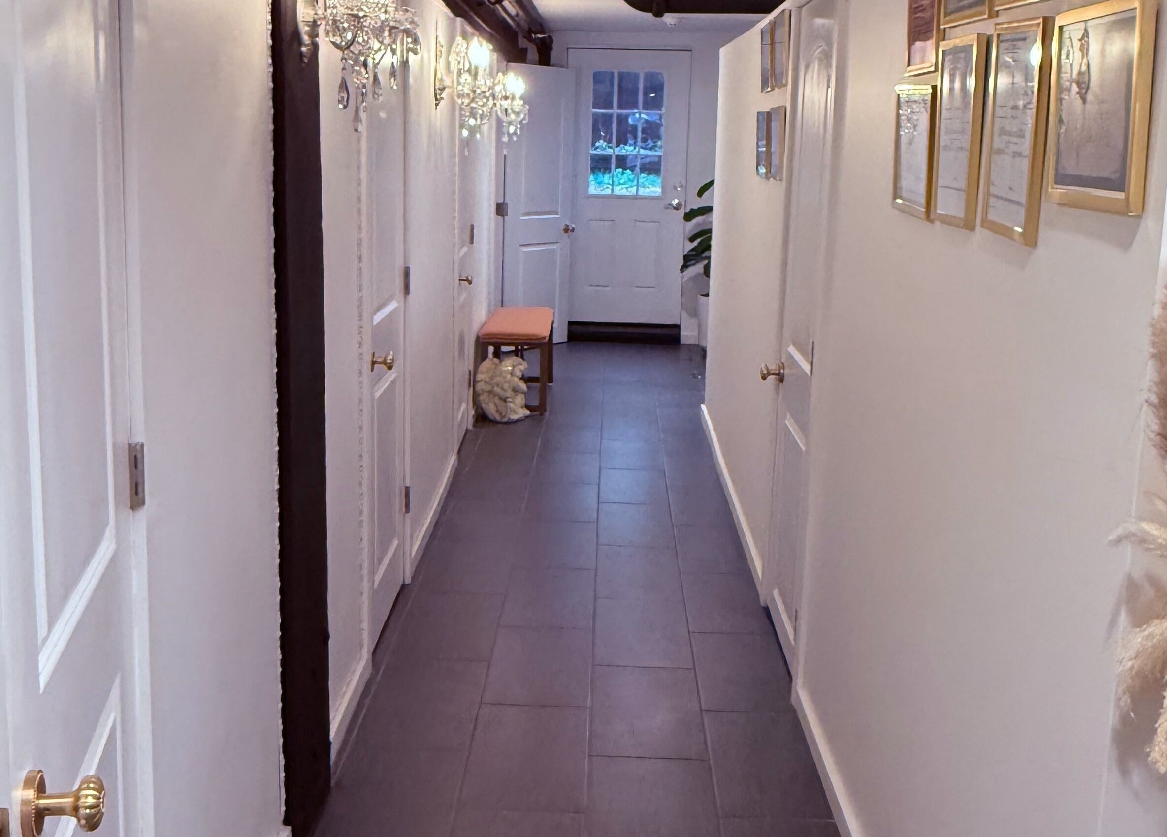 Bright hallway at Spa Maluge in Hoboken, New Jersey, US, featuring chic decor and ambient lighting.