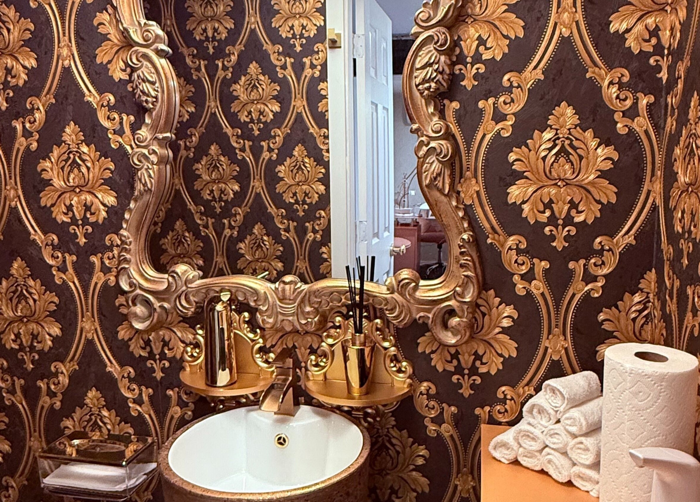 Luxurious Baroque-style decor at Spa Maluge in Hoboken, New Jersey, US featuring ornate mirror and gold accents.