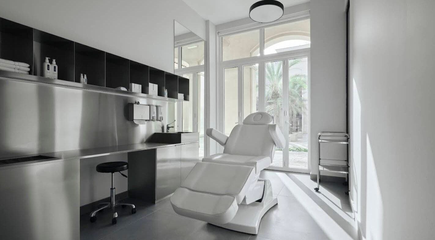 Spacious, modern treatment room at Elegant Ink Studio, Abu Dhabi, Abu Dhabi, AE with a reclining chair and large windows.