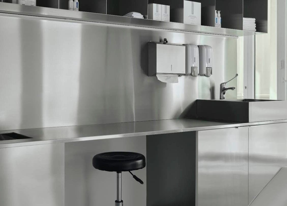 Modern workspace at Elegant Ink Studio, Abu Dhabi, Abu Dhabi, AE with stainless steel design.