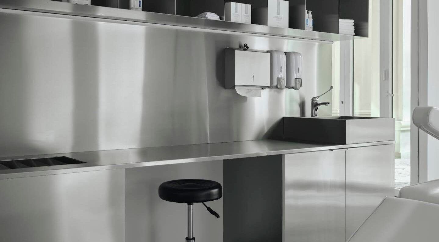 Modern workspace at Elegant Ink Studio, Abu Dhabi, Abu Dhabi, AE with stainless steel design.