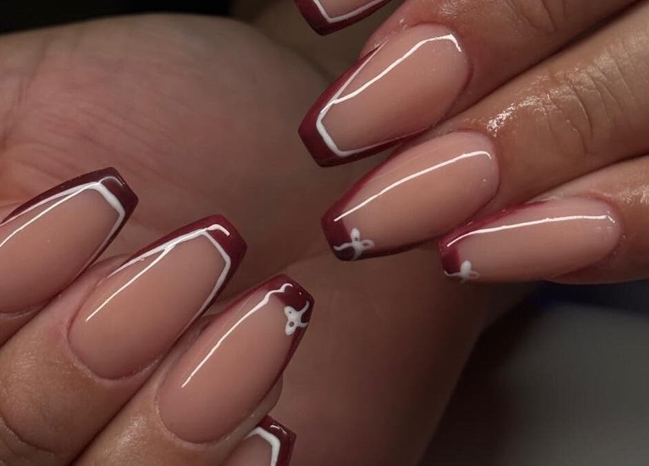 Stylish French manicure with maroon tips at Madison - Beauty Studio, Poole, England, GB.
