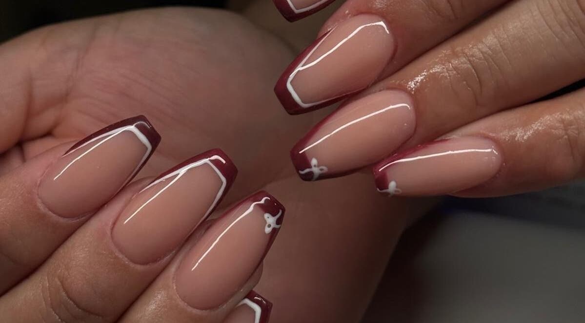 Stylish French manicure with maroon tips at Madison - Beauty Studio, Poole, England, GB.