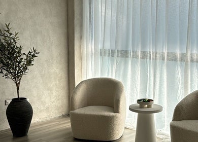 Relaxing corner at Beaute Society, Rosebery, New South Wales, AU with cozy chairs and natural light.