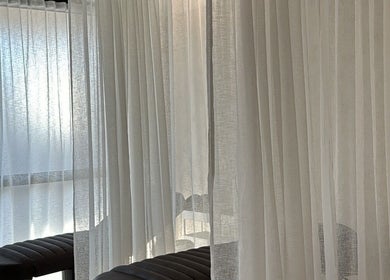 Elegant relaxation area with sheer curtains at Beaute Society, Rosebery, New South Wales, AU.