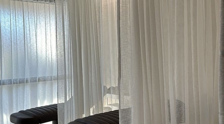 Elegant relaxation area with sheer curtains at Beaute Society, Rosebery, New South Wales, AU.